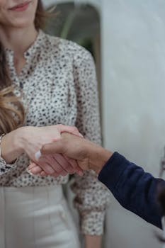 Close-up of a professional handshake between two diverse business associates in an indoor setting.